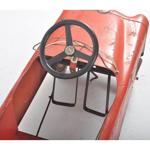 550 - Sharna Tri-ang Limited - A retro vintage 20th Century tinplate pedal car finished in red with white ... 