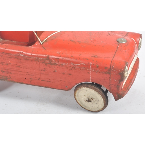 550 - Sharna Tri-ang Limited - A retro vintage 20th Century tinplate pedal car finished in red with white ... 