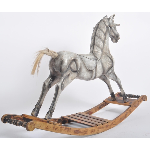 566 - A vintage 20th Century carved wooden rocking horse with detailed carved face a mane with a carved sa... 