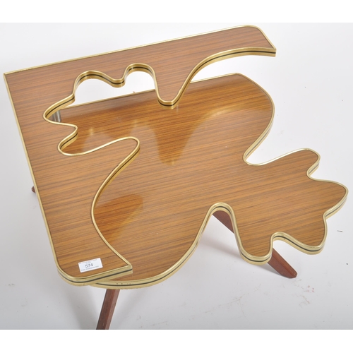 574 - A retro vintage mid 20th Century coffee table of unusual puzzle piece form. Cut out raised section a... 