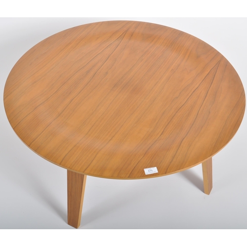 575 - After Charles & Ray Eames - CTW - A contemporary walnut coffee table of circular form raised on bent... 