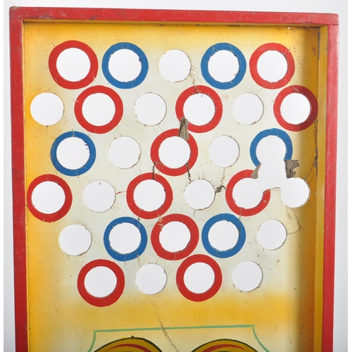 586 - A vintage mid 20th Century fairground / funfair hand painted wooden roller ball game with holes to t... 