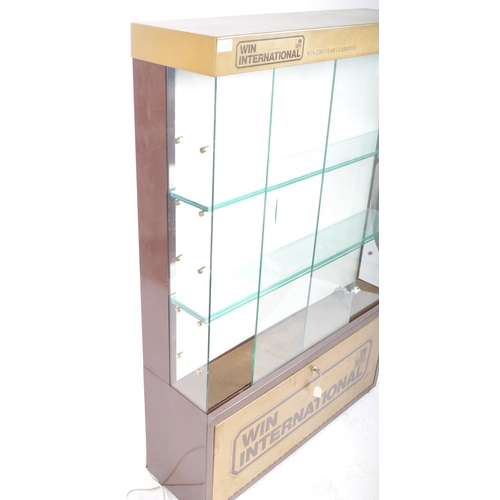 588 - A late 20th Century Win International advertising glass shop display cabinet with twin glazed doors ... 