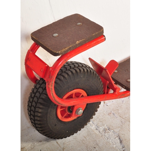 589 - A vintage 20th Century children's scooter finished in red with wooden plinth standing borders and st... 