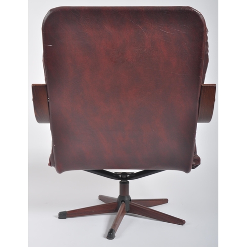 592 - A retro mid 20th Century bentwood & leather swivel lounge chair / easy armchair having a bentwood fr... 