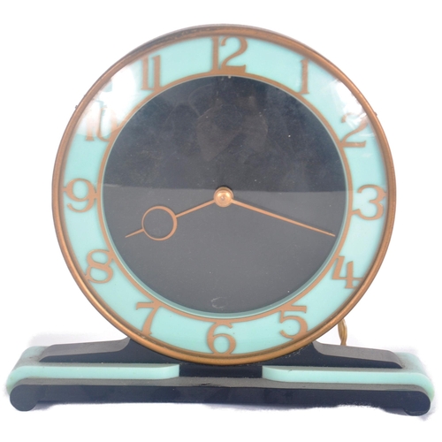 664 - Smiths - A vintage 20th Century Art Deco bakelite mantel clock having a circular dial in blue and bl... 