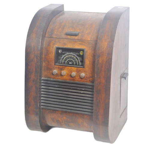 665 - A retro mid 20th Century patented combination radio, gramophone and record cabinet of walnut constru... 