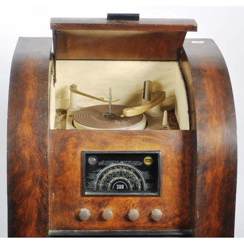 665 - A retro mid 20th Century patented combination radio, gramophone and record cabinet of walnut constru... 