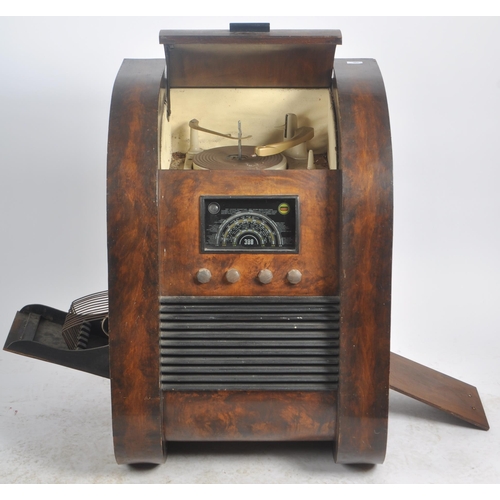 665 - A retro mid 20th Century patented combination radio, gramophone and record cabinet of walnut constru... 