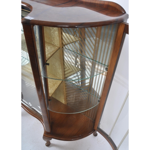 78 - A vintage 20th Century Art Deco walnut breakfront display cabinet vitrine having bowed glass doors t... 