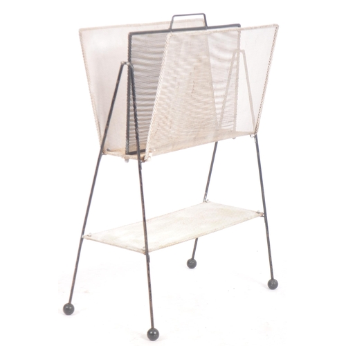 82 - Mathieu Mategot - A retro mid 20th Century perforated metal magazine rack of slender upright form wi... 