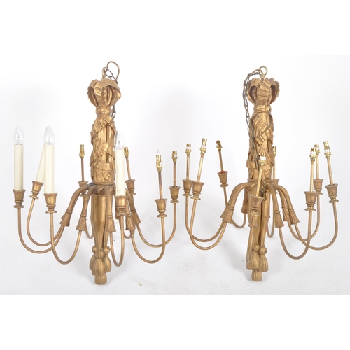 88 - A matching pair of 20th Century gilt wood hanging chandeliers / electrolier. Each having eight branc... 