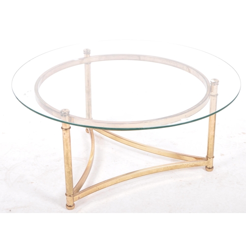 98 - A 20th Century 1980s Hollywood Regency brass framed coffee table / low table of circular form having... 