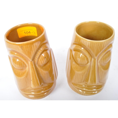 104 - A pair of 20th Century West German pottery vases by Scheurich. Both in the form of Easter Island hea... 