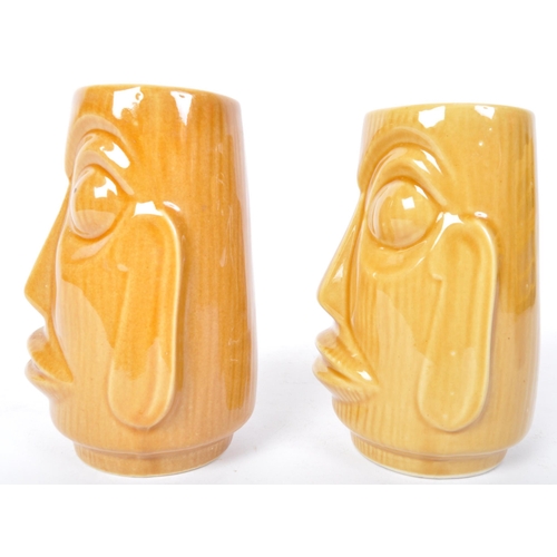 104 - A pair of 20th Century West German pottery vases by Scheurich. Both in the form of Easter Island hea... 