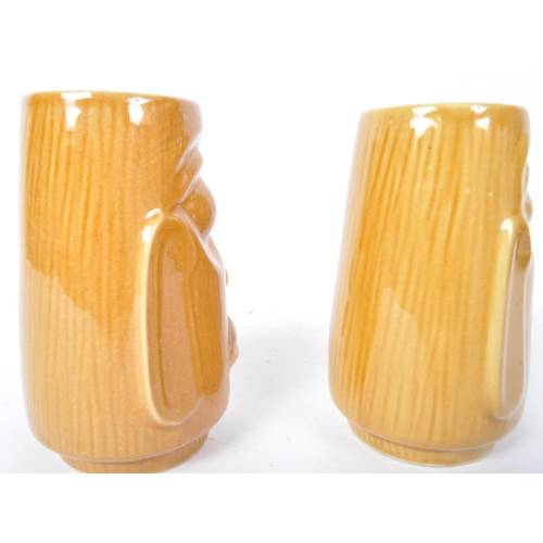 104 - A pair of 20th Century West German pottery vases by Scheurich. Both in the form of Easter Island hea... 