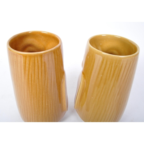 104 - A pair of 20th Century West German pottery vases by Scheurich. Both in the form of Easter Island hea... 