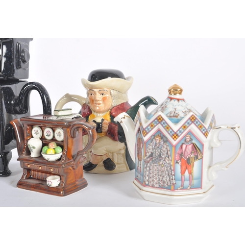 165 - A collection of 20th Century Paul Cardew & other novelty ceramic teapots. Each of unusual form with ... 