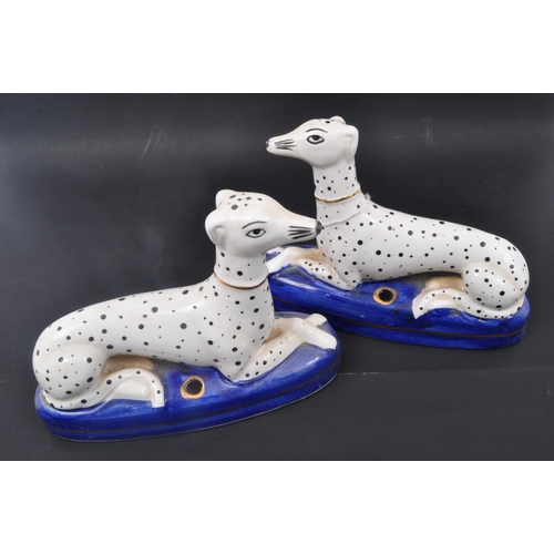 190 - A pair of 19th century Victorian Staffordshire Dalmatians dog figures sitting upon cobalt plinth bas... 