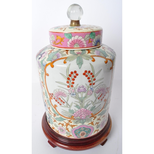 20 - A vintage 20th century ceramic Chinese Oriental spice jar on wooden base. The vase having a circular... 