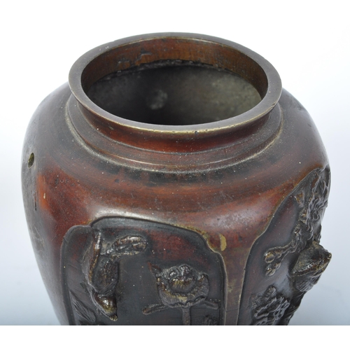 201 - A 20th Century Japanese bronze vase. AF. Having a lipped top with tapering body with four panels dep... 