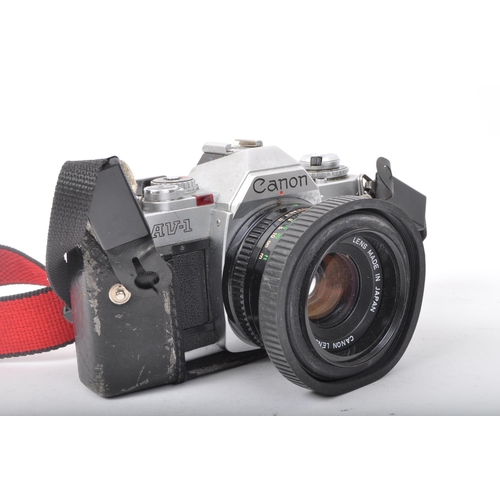 221 - A vintage retro 1979 Canon AV-1 camera. Made in Japan. Canon lens FD 50mm 1:1.8. With original red f... 