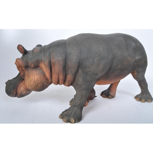 227 - A 20th century resin hippopotamus sculpture modelled in the form of a hippo with infant by is side. ... 