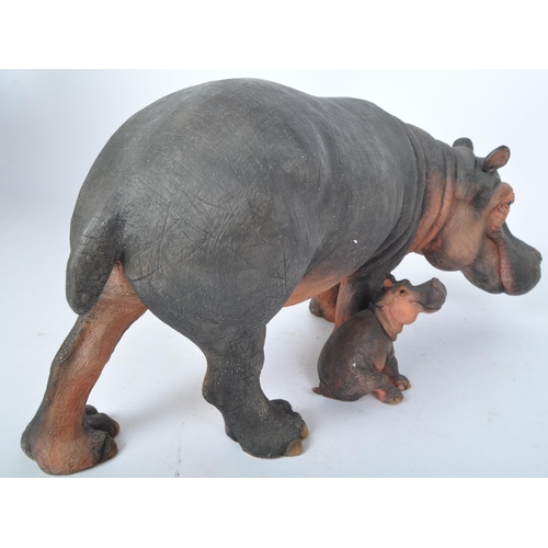 227 - A 20th century resin hippopotamus sculpture modelled in the form of a hippo with infant by is side. ... 