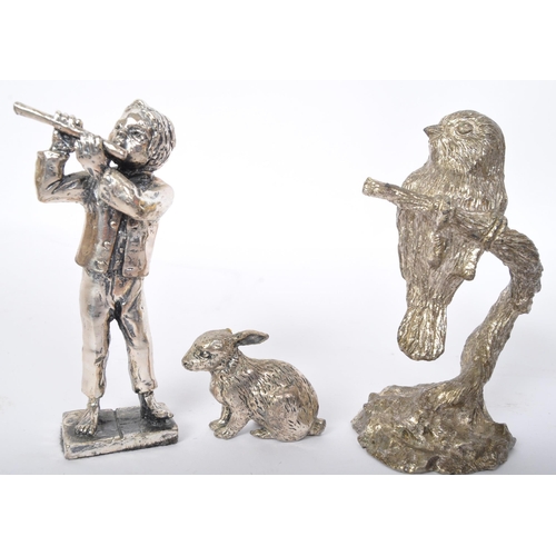 235 - An assortment of cast metal spelter figures to include King Arthur, owls, rabbits, a Dickensian gent... 