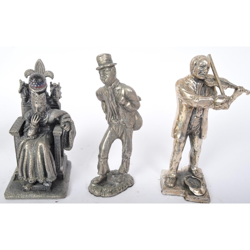 235 - An assortment of cast metal spelter figures to include King Arthur, owls, rabbits, a Dickensian gent... 