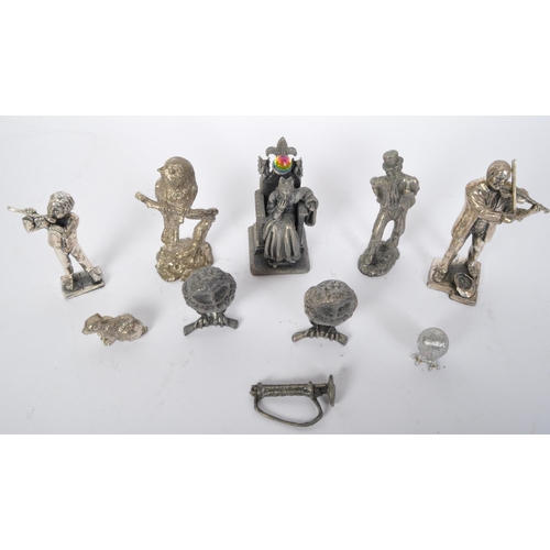 235 - An assortment of cast metal spelter figures to include King Arthur, owls, rabbits, a Dickensian gent... 