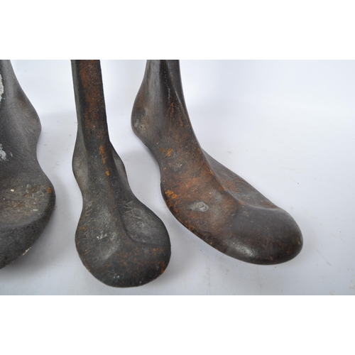 245 - An assortment of early 20th century cast iron shoe makers cobblers lasts. Various sizes and all stam... 