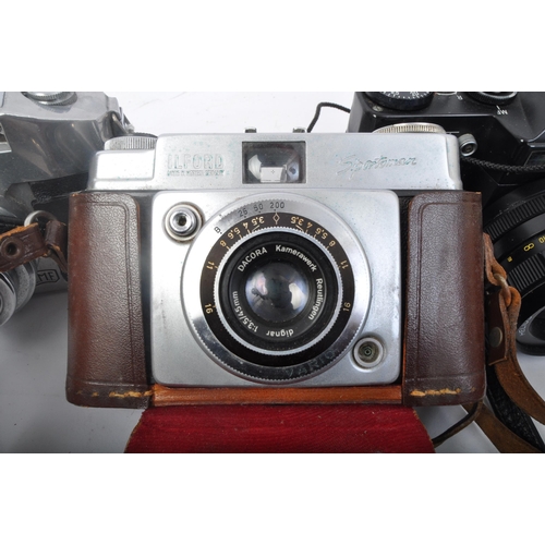 251 - An assortment of four retro vintage 20th century photographic cameras. The lot to include a Asahi Pe... 