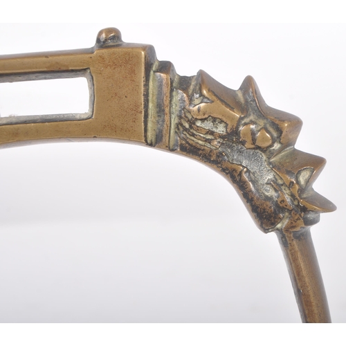 260 - An early 20th Century Chinese Oriental bronze horse stirrup. Ornate arched top with dragon heads lea... 