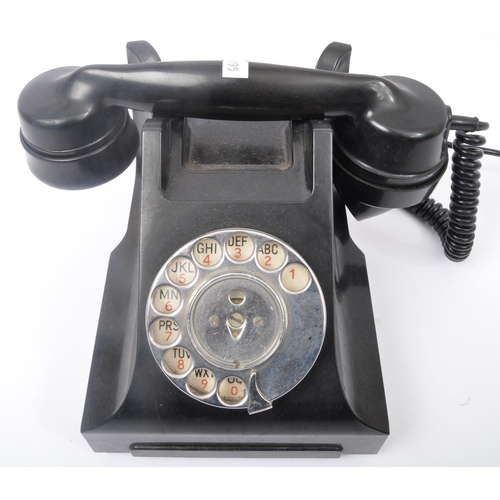 262 - A vintage 20th Century Art Deco bakelite ring dial telephone of typical form finished in black. The ... 