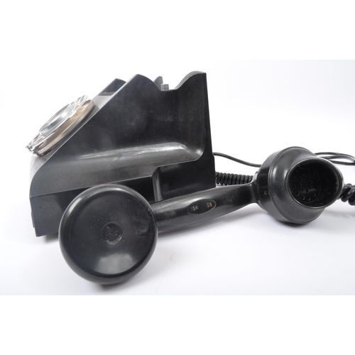 262 - A vintage 20th Century Art Deco bakelite ring dial telephone of typical form finished in black. The ... 