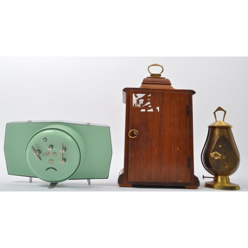 278 - A collection of three vintage retro mid 20th century clocks to include a Swiza eight jewels clock in... 