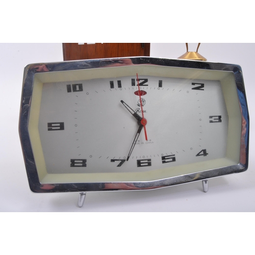 278 - A collection of three vintage retro mid 20th century clocks to include a Swiza eight jewels clock in... 