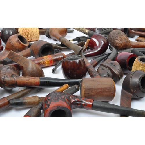 282 - A large extensive collection of 19th century and later smoking tobacco pipes to include carved Black... 