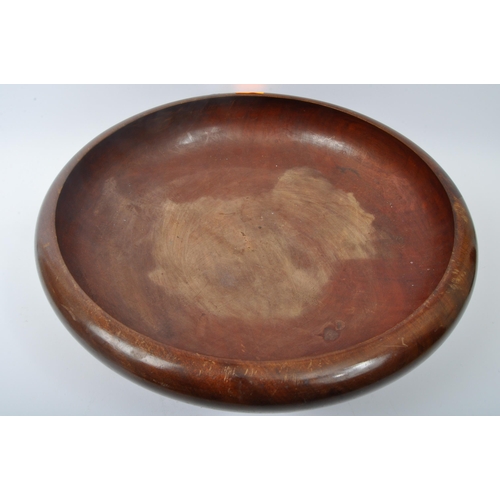 284 - A large 20th century turned hardwood centrepiece bowl with squat up curled edge. Measures 45cm diame... 