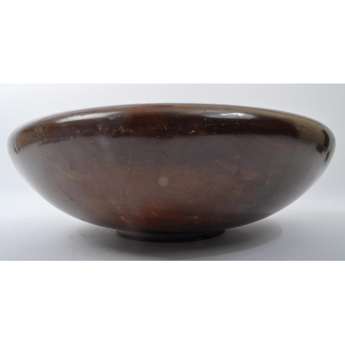 284 - A large 20th century turned hardwood centrepiece bowl with squat up curled edge. Measures 45cm diame... 