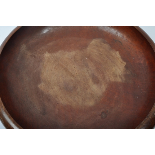 284 - A large 20th century turned hardwood centrepiece bowl with squat up curled edge. Measures 45cm diame... 