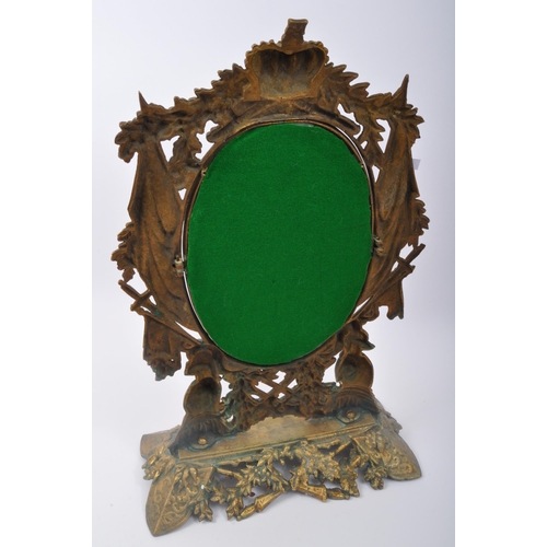 286 - A 20th century gilt metal table top mirror having pierced heraldic decoration to frame with crown, k... 