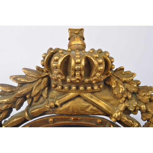 286 - A 20th century gilt metal table top mirror having pierced heraldic decoration to frame with crown, k... 