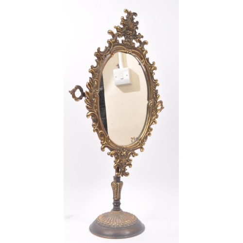 292 - An early 20th century gilt metal table top tilting mirror. The mirror having pierced rocaille detail... 