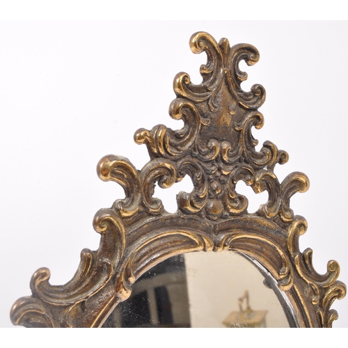 292 - An early 20th century gilt metal table top tilting mirror. The mirror having pierced rocaille detail... 