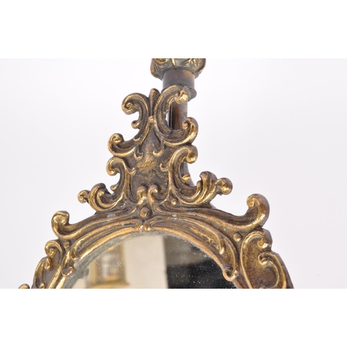 292 - An early 20th century gilt metal table top tilting mirror. The mirror having pierced rocaille detail... 