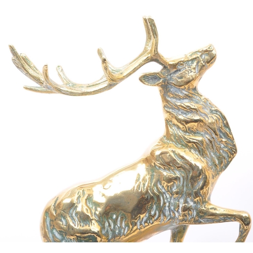 304 - Two 20th century brass sculptures in the form of moose, each raised on socale bases. Together with a... 