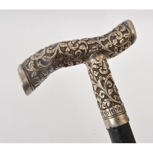 310 - A 19th century Victorian walking stick. The walking stick having silver white metal repousse handle ... 