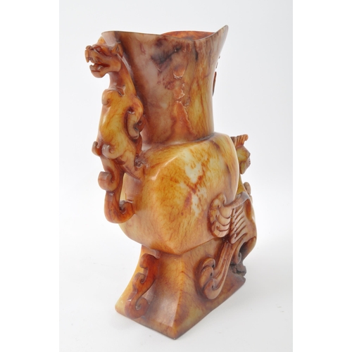 314 - An early 20th century Chinese carved soapstone vase. The vase having anthropologic carved phoenix an... 